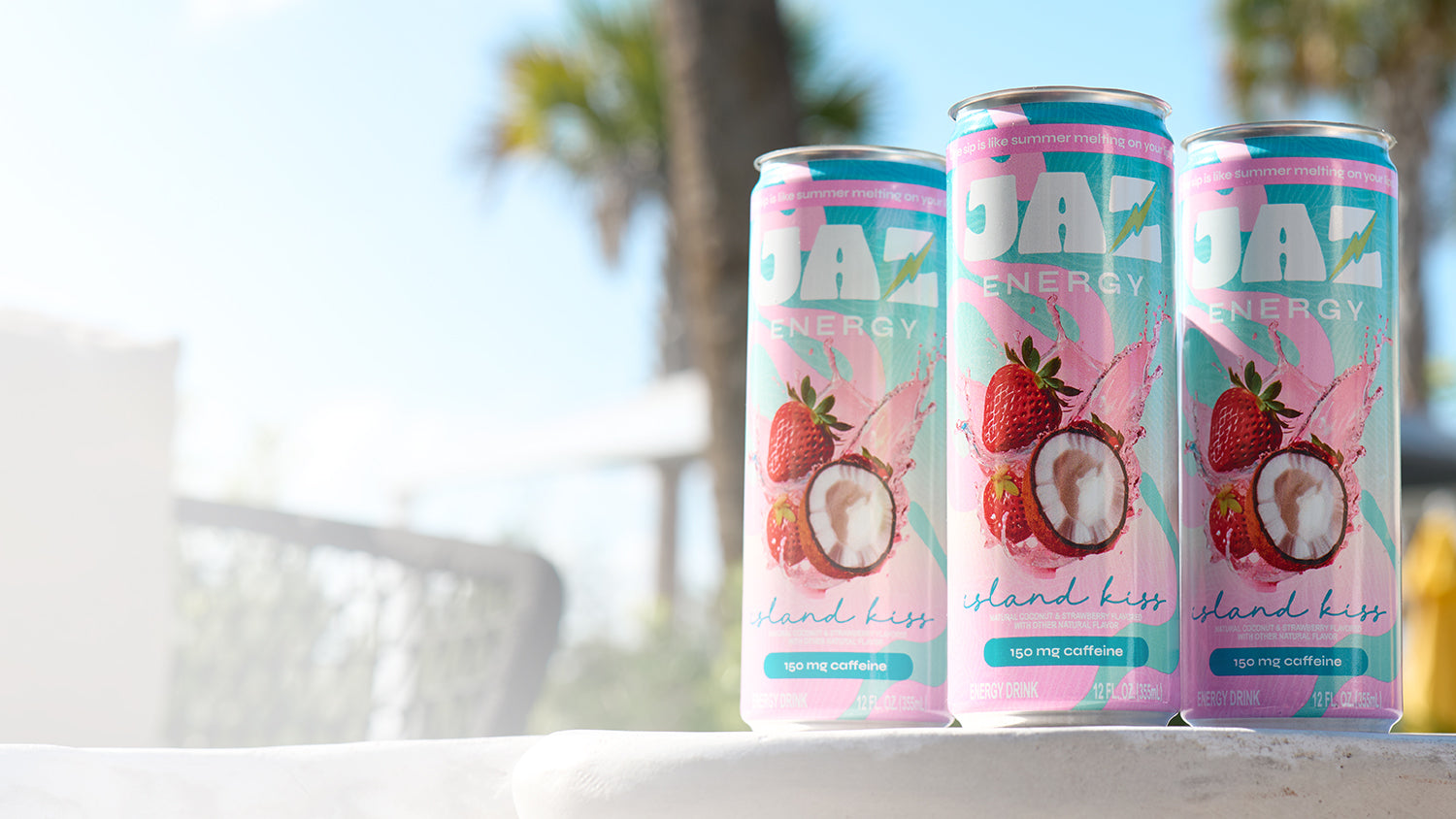 Three Jaz Energy cans on the beach – clean energy drinks for an active, outdoor lifestyle with no crash.