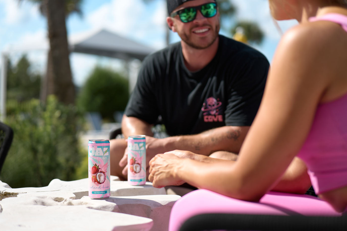 Two people sitting outdoors with drinks on a table